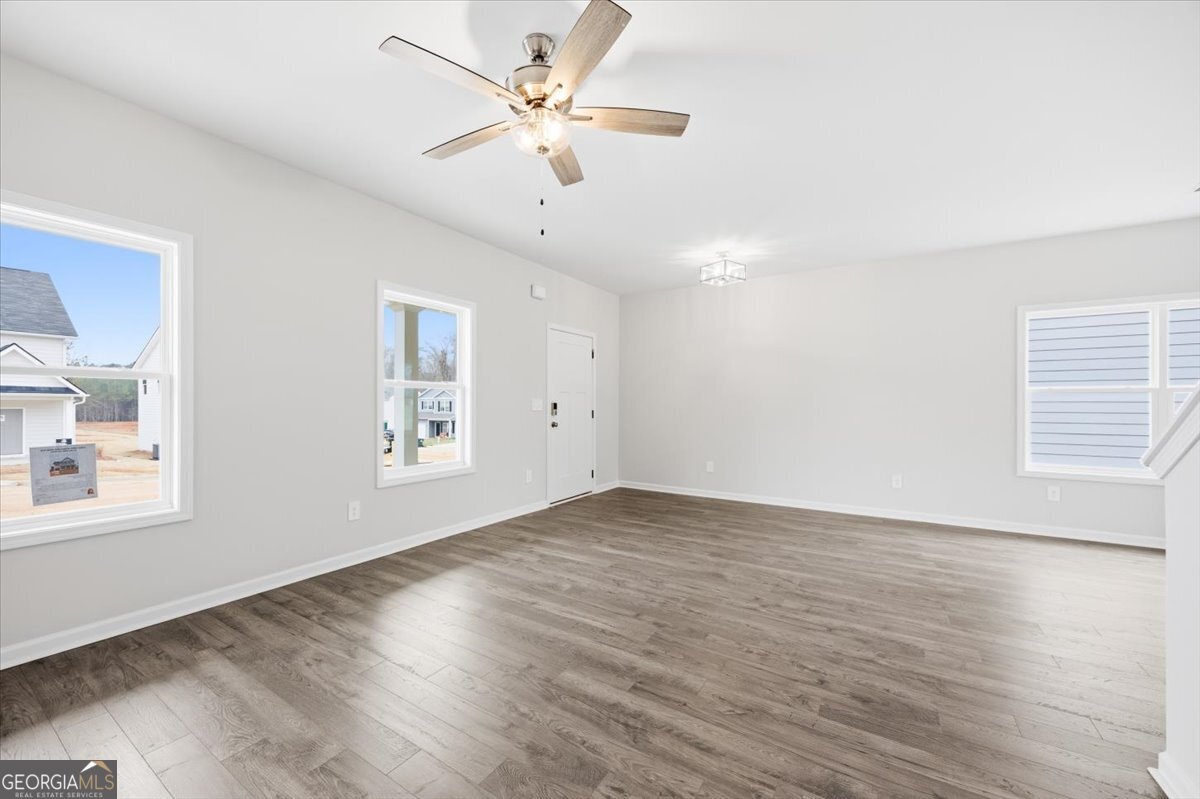 5 Morningside Court Thomaston, GA 30286 - Photo 6 of 26 an empty room with wooden floor fan and windows