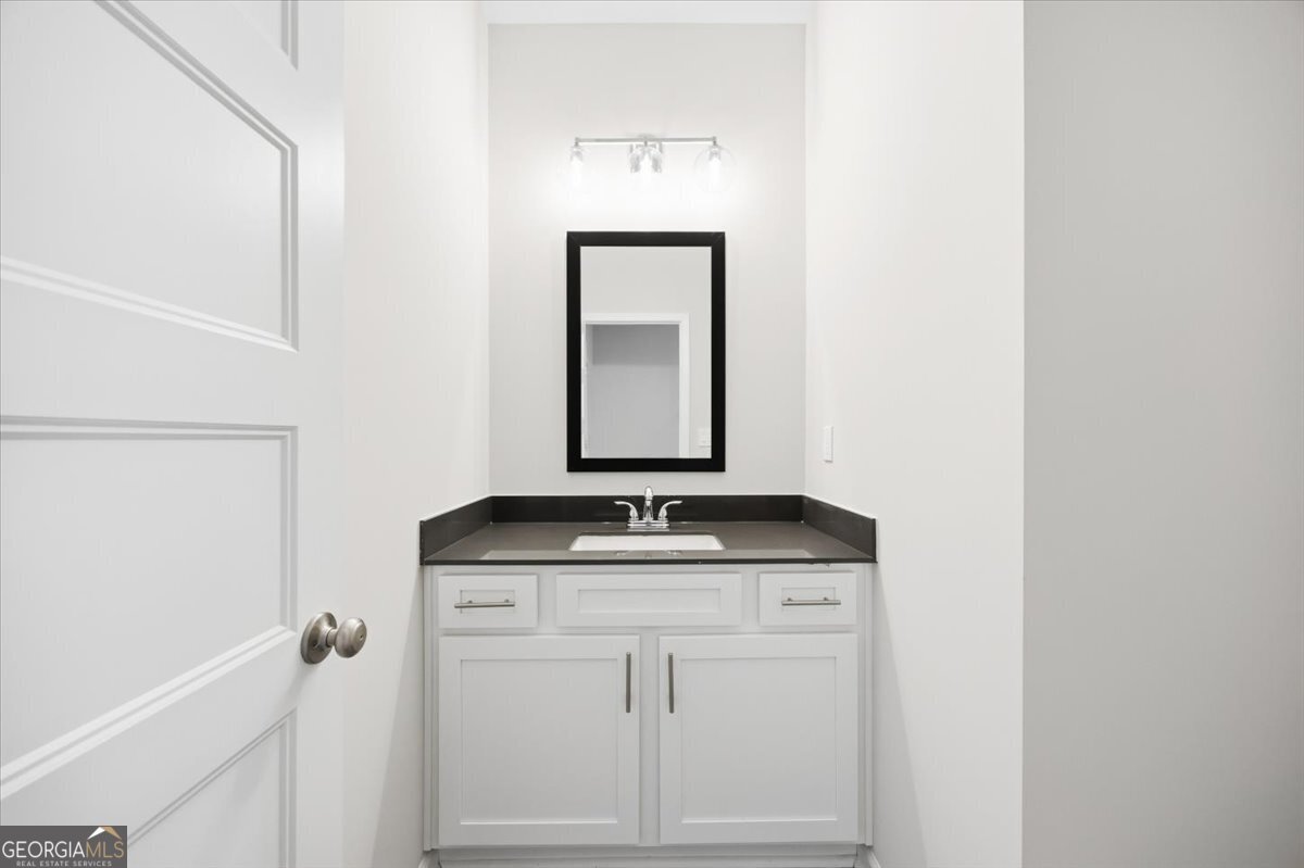 5 Morningside Court Thomaston, GA 30286 - Photo 10 of 26 a bathroom with a granite countertop sink and vanity