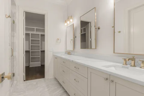 a bathroom with a double vanity sink and a mirror