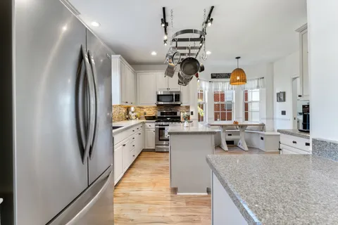 a kitchen with a sink cabinets and window