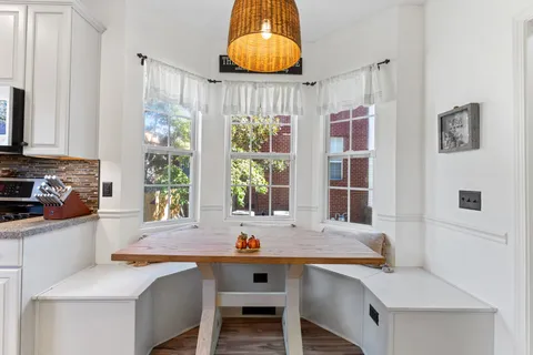 a kitchen with granite countertop white cabinets and appliances