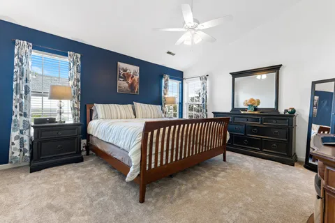 a bedroom with a large bed and a flat screen tv