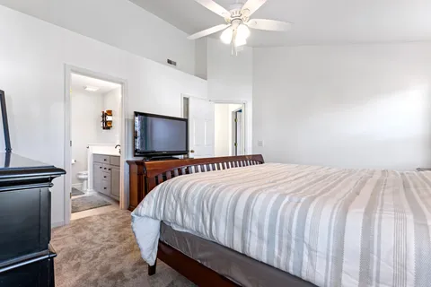 a spacious bathroom with a granite countertop sink a mirror and shower