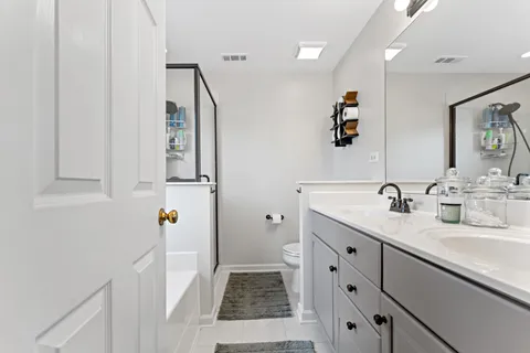 a white bath tub with shower