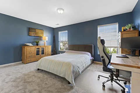 a bedroom with a bed and a large window