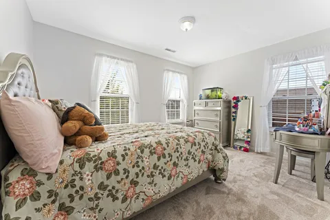 a bedroom with a bed and a table in it