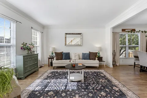 a living room with furniture and wooden floor