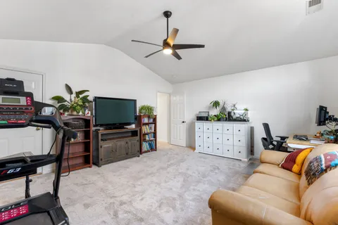 a view of a balcony with furniture and wooden floor