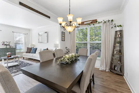 a view of a dining room with furniture window and wooden floor