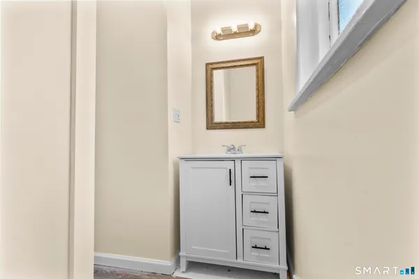 a bathroom with a sink a mirror and a toilet