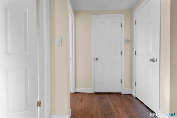 a view of an empty room and wooden floor