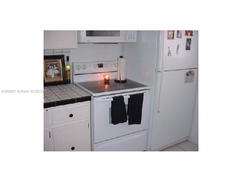 17900 North Bay Road, Unit PH3 Sunny Isles Beach, FL 33160 - Photo 6 of 18 a kitchen with cabinets and stainless steel appliances