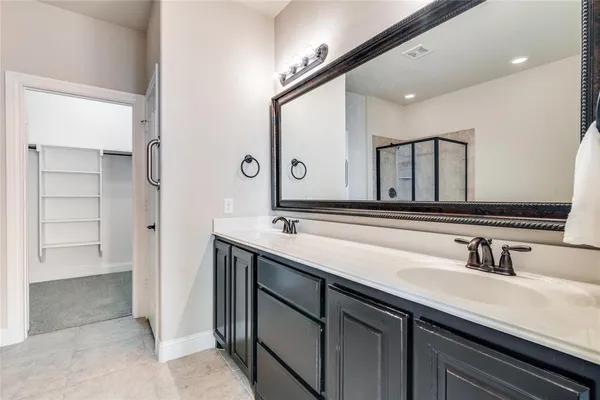 a bathroom with a double vanity sink and a mirror