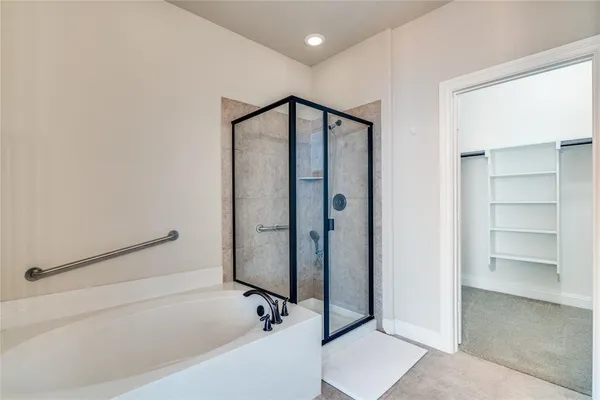 a bathroom with a bathtub and a shower