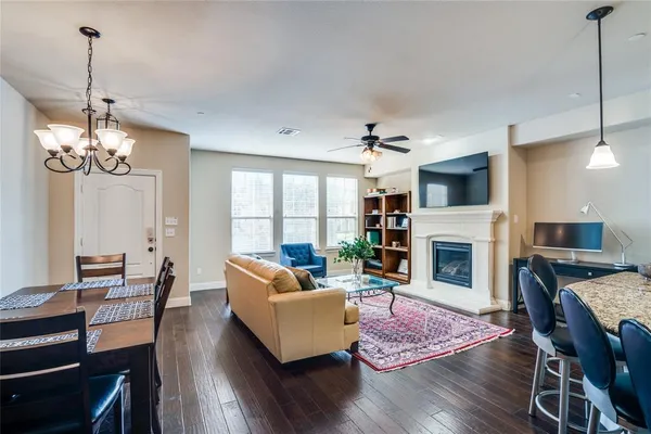 a living room with fireplace furniture and a wooden floor