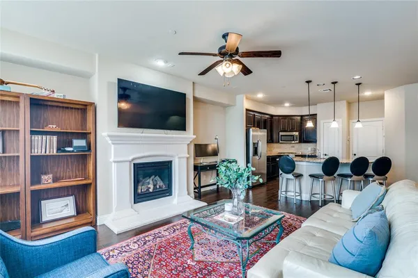 a living room with furniture a flat screen tv and a fireplace