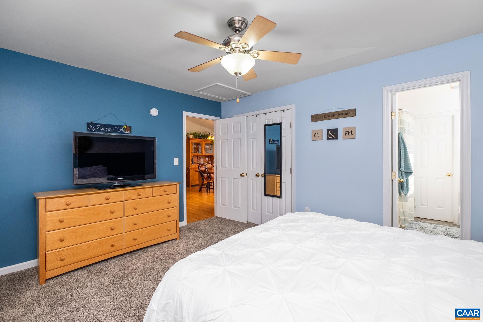 768 West Daffodil Road Ruckersville, VA 22968 - Photo 17 of 36 a bedroom with a bed and a flat screen tv