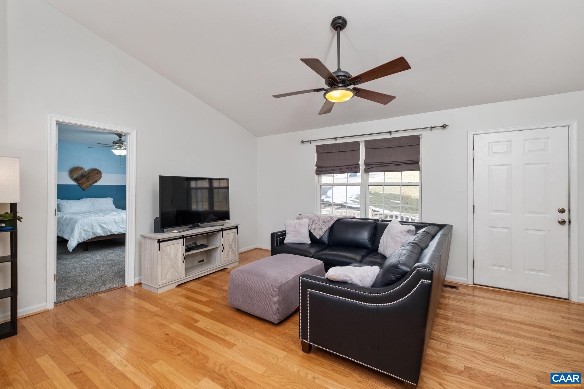 768 West Daffodil Road Ruckersville, VA 22968 - Photo 8 of 36 a living room with furniture and a flat screen tv