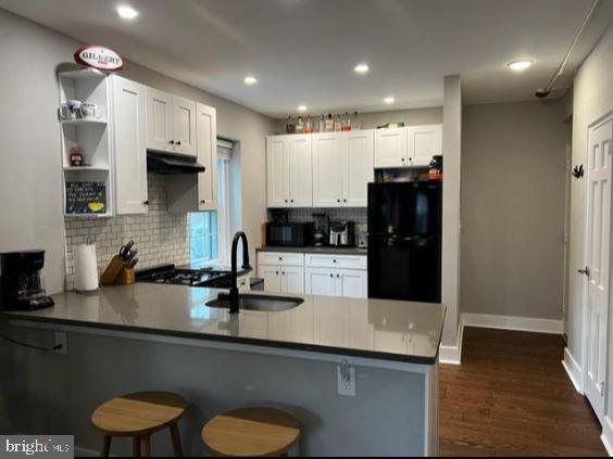 a kitchen with a sink and white appliances
