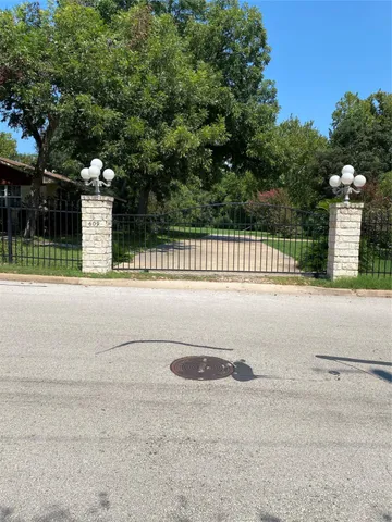 a view of swimming pool with a big yard and large trees