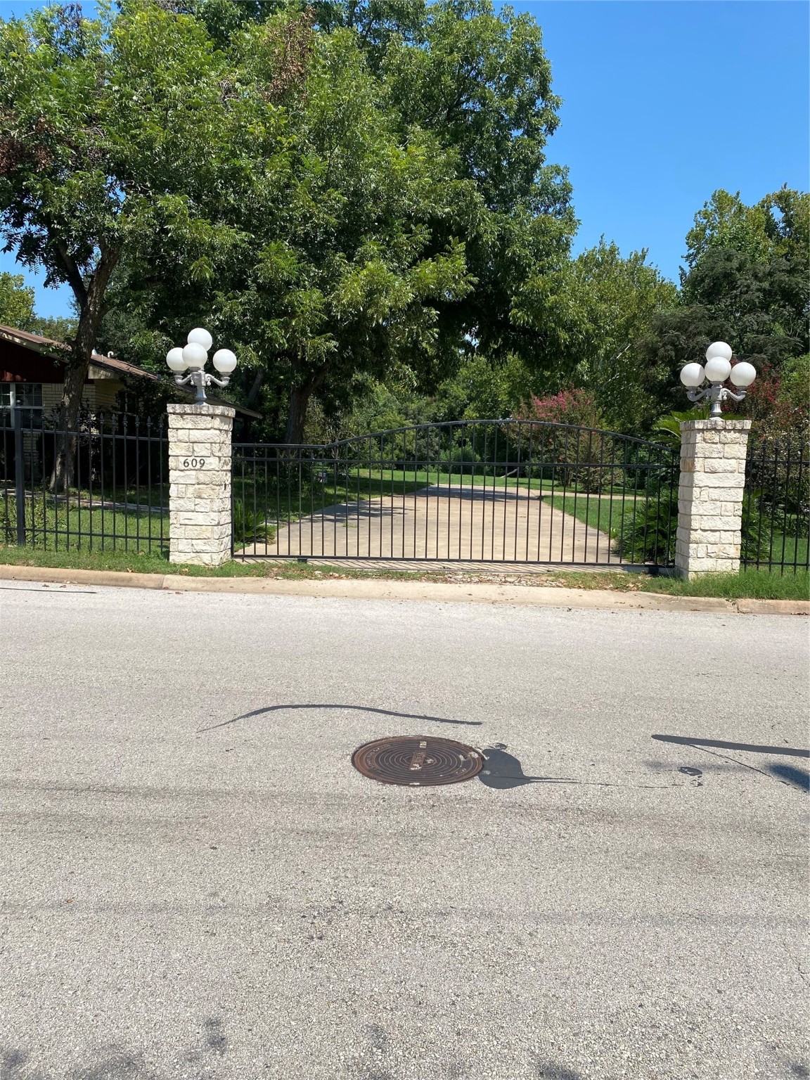 a view of swimming pool with a big yard and large trees