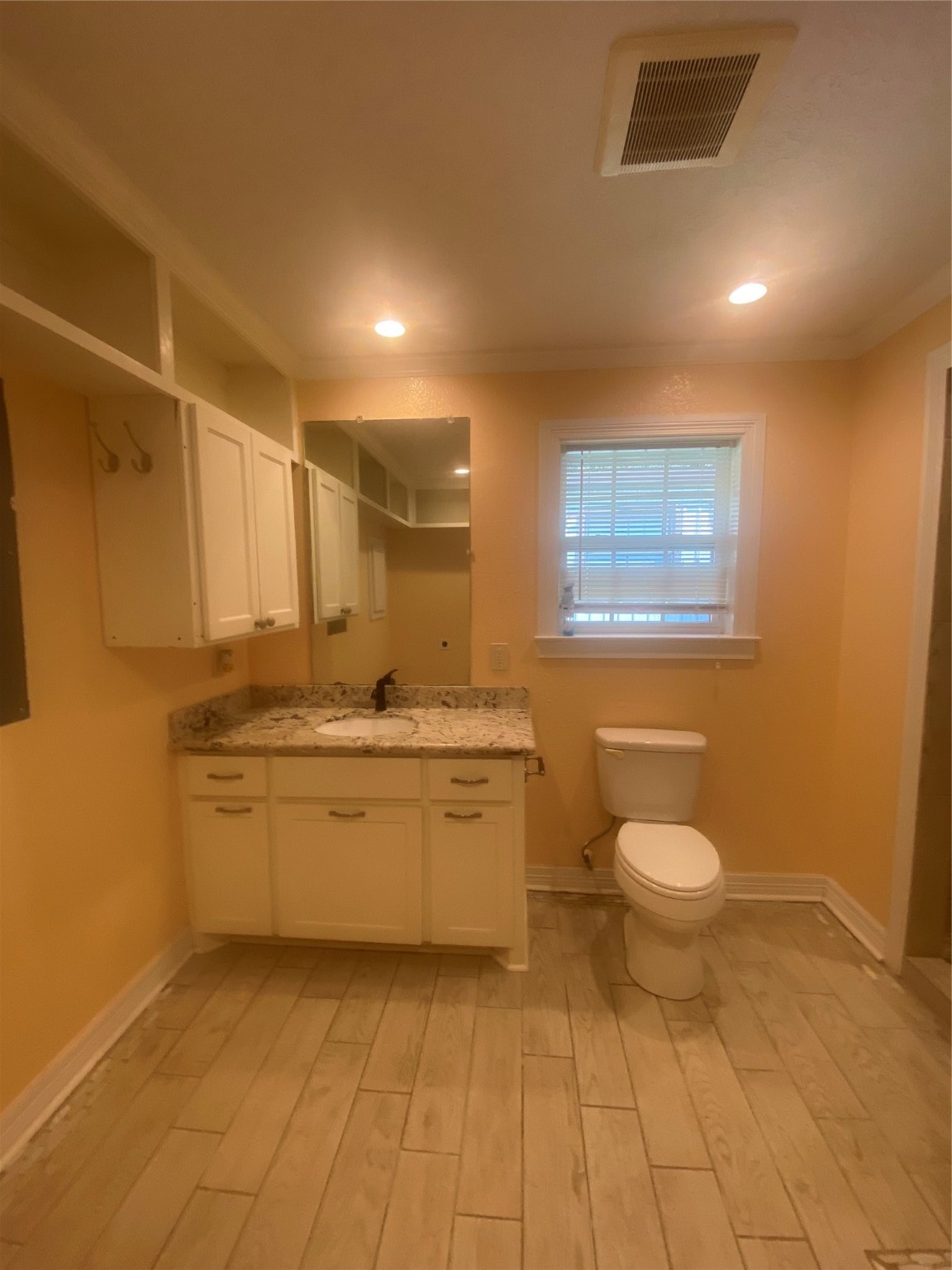 609 Kerr Street Brenham, TX 77833 - Photo 16 of 34 a bathroom with a granite countertop toilet a sink and mirror