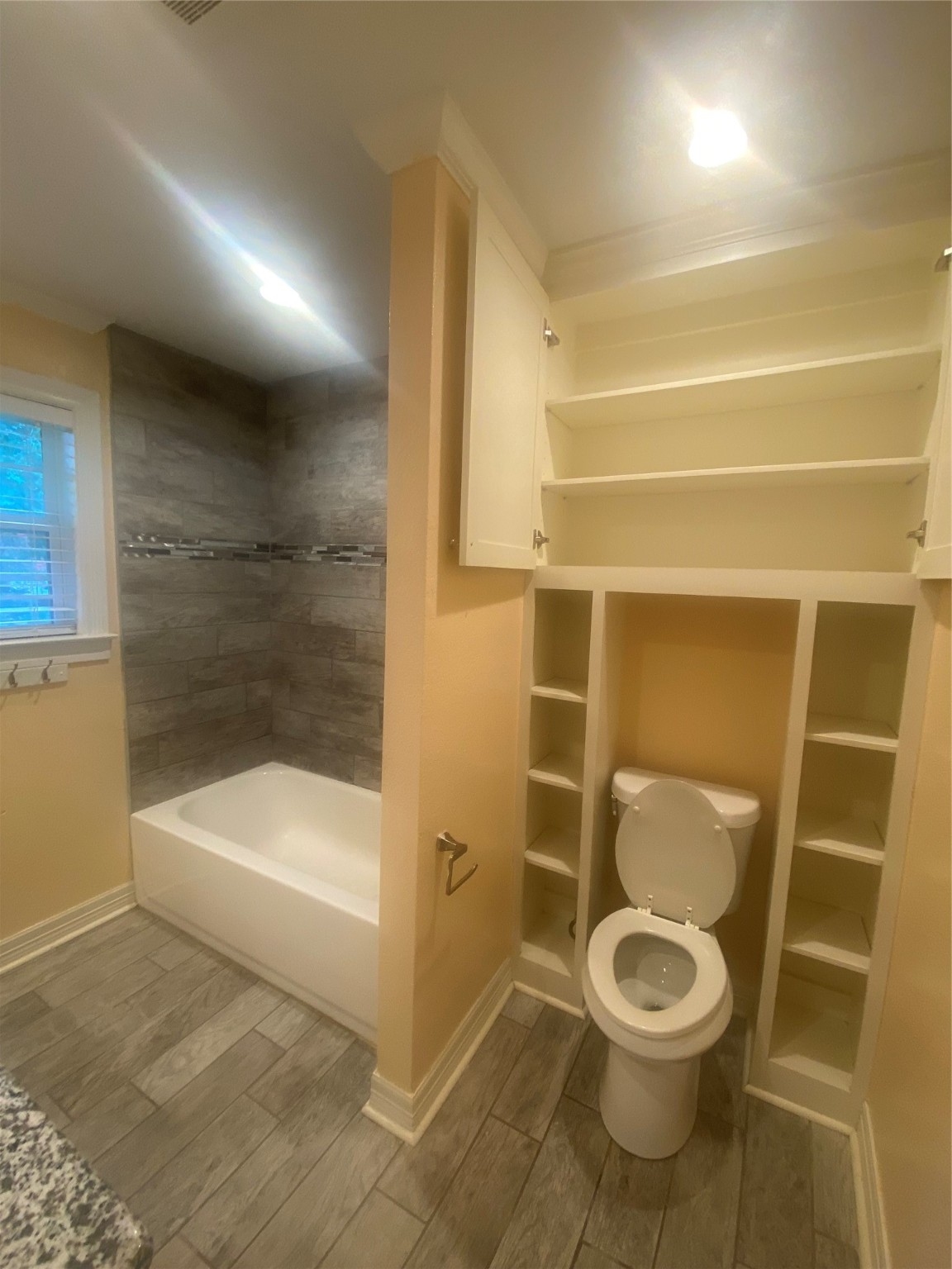 609 Kerr Street Brenham, TX 77833 - Photo 23 of 34 a bathroom with a toilet and a shower
