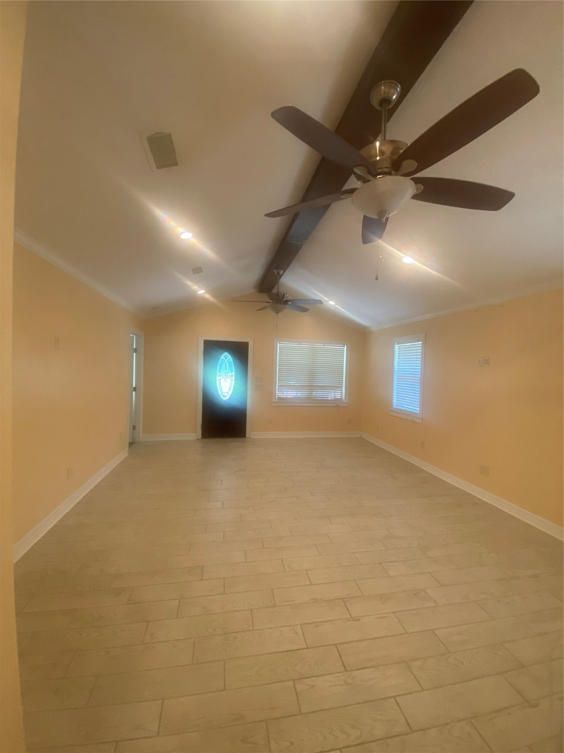 609 Kerr Street Brenham, TX 77833 - Photo 7 of 34 an empty room with windows and fan