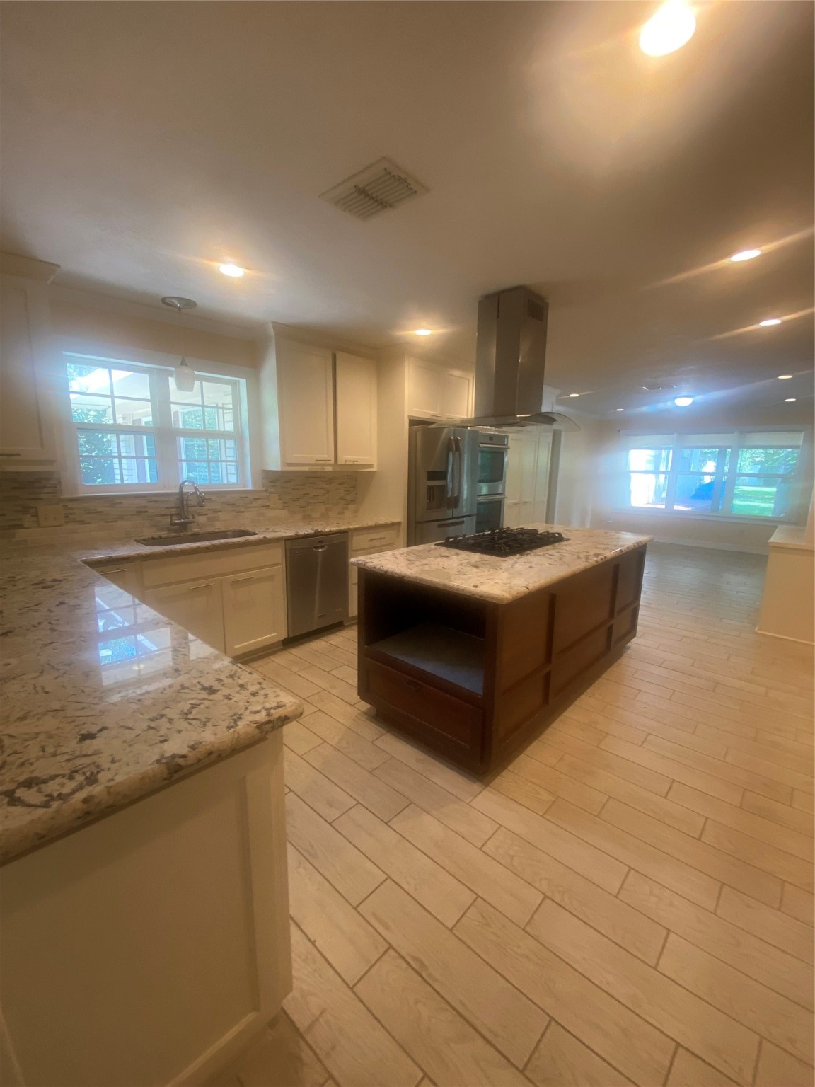609 Kerr Street Brenham, TX 77833 - Photo 9 of 34 a large kitchen with stainless steel appliances a large counter top a stove and a sink