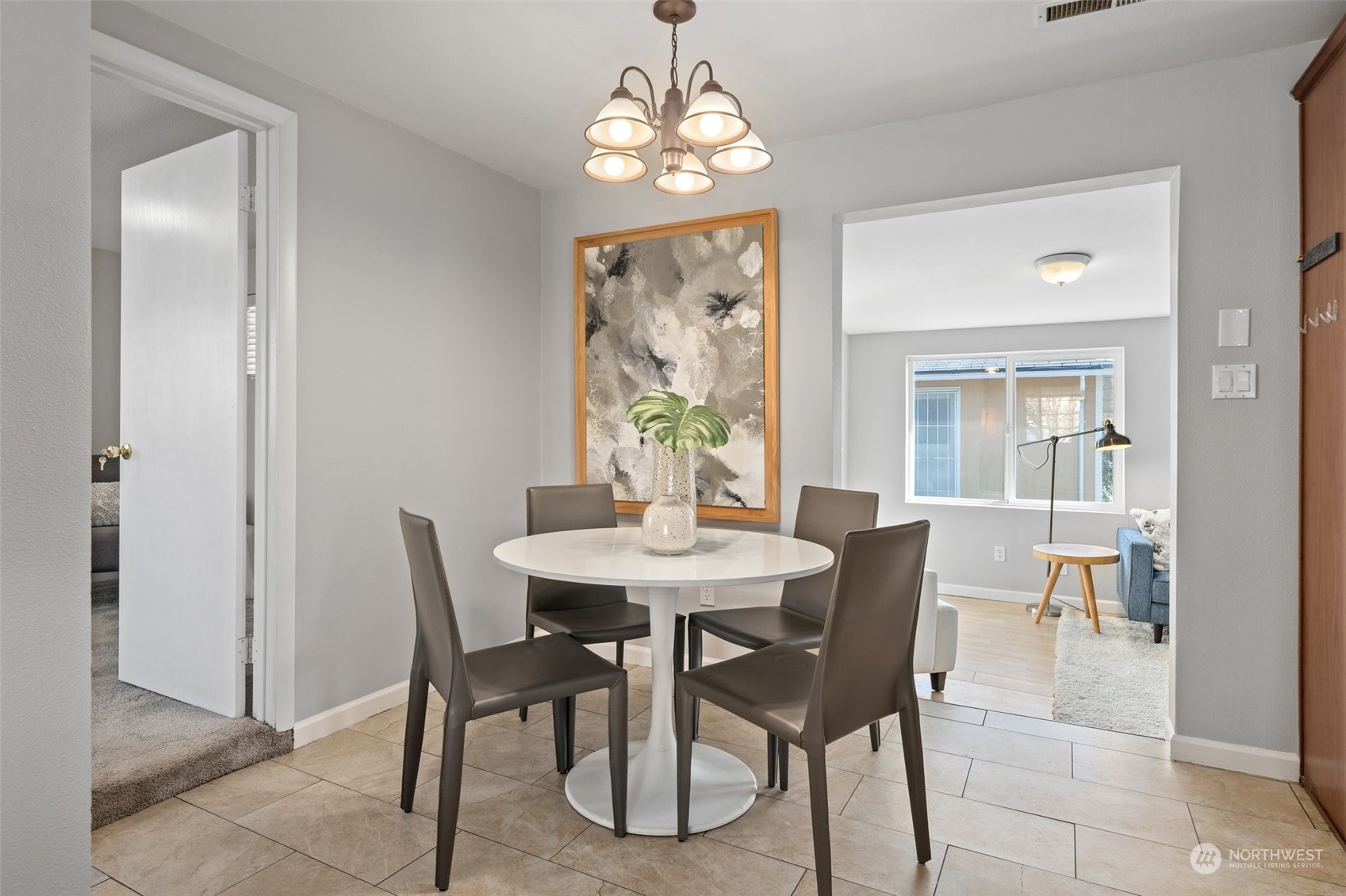 12645 Southeast 170th Street Renton, WA 98058 - Photo 11 of 37 a dining room with furniture a rug and a chandelier