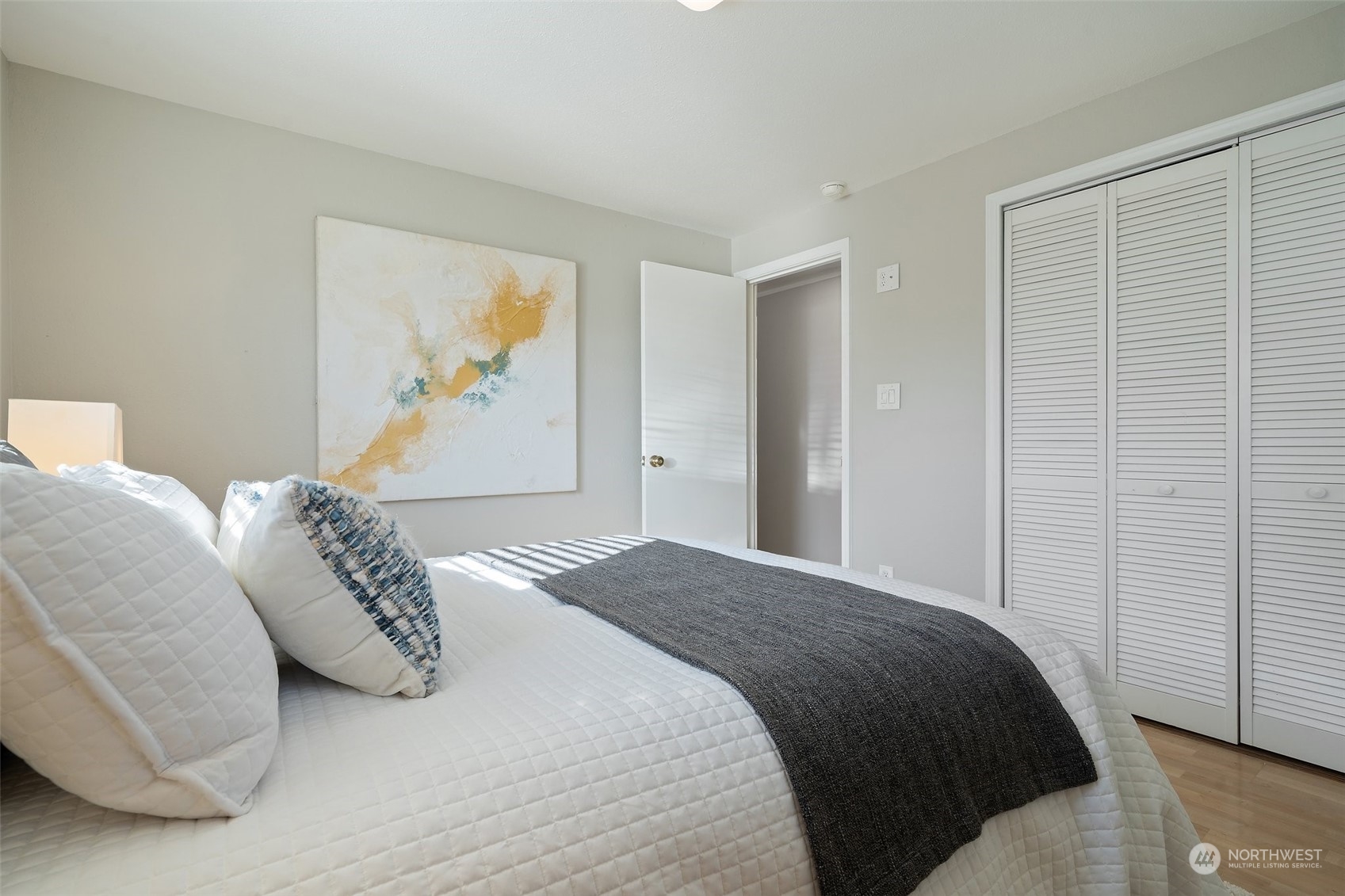 12645 Southeast 170th Street Renton, WA 98058 - Photo 19 of 37 a bedroom with a bed and a painting on the wall