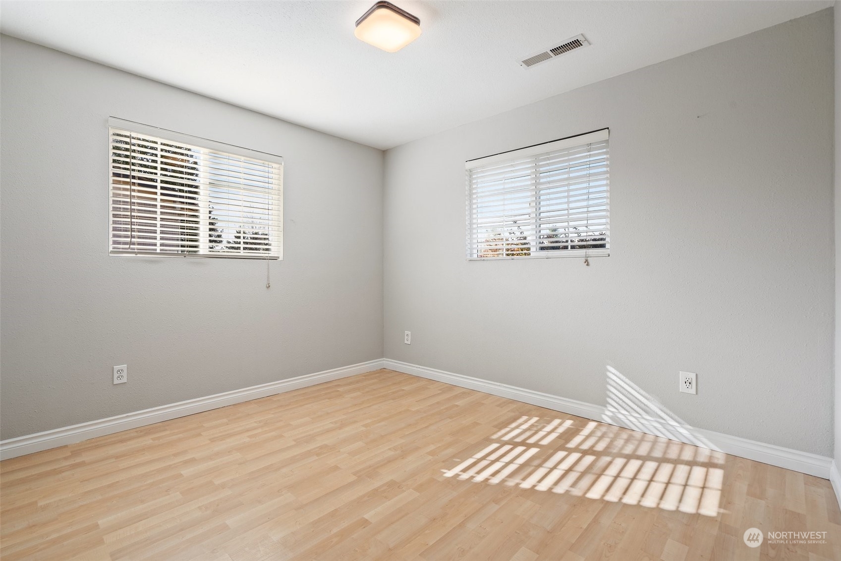12645 Southeast 170th Street Renton, WA 98058 - Photo 21 of 37 a view of an empty room with wooden floor and a window