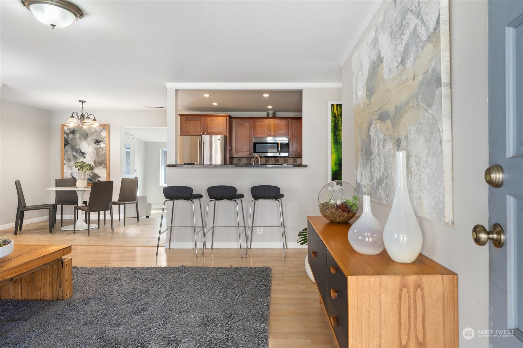 12645 Southeast 170th Street Renton, WA 98058 - Photo 4 of 37 a living room with furniture a chandelier and a wooden floor