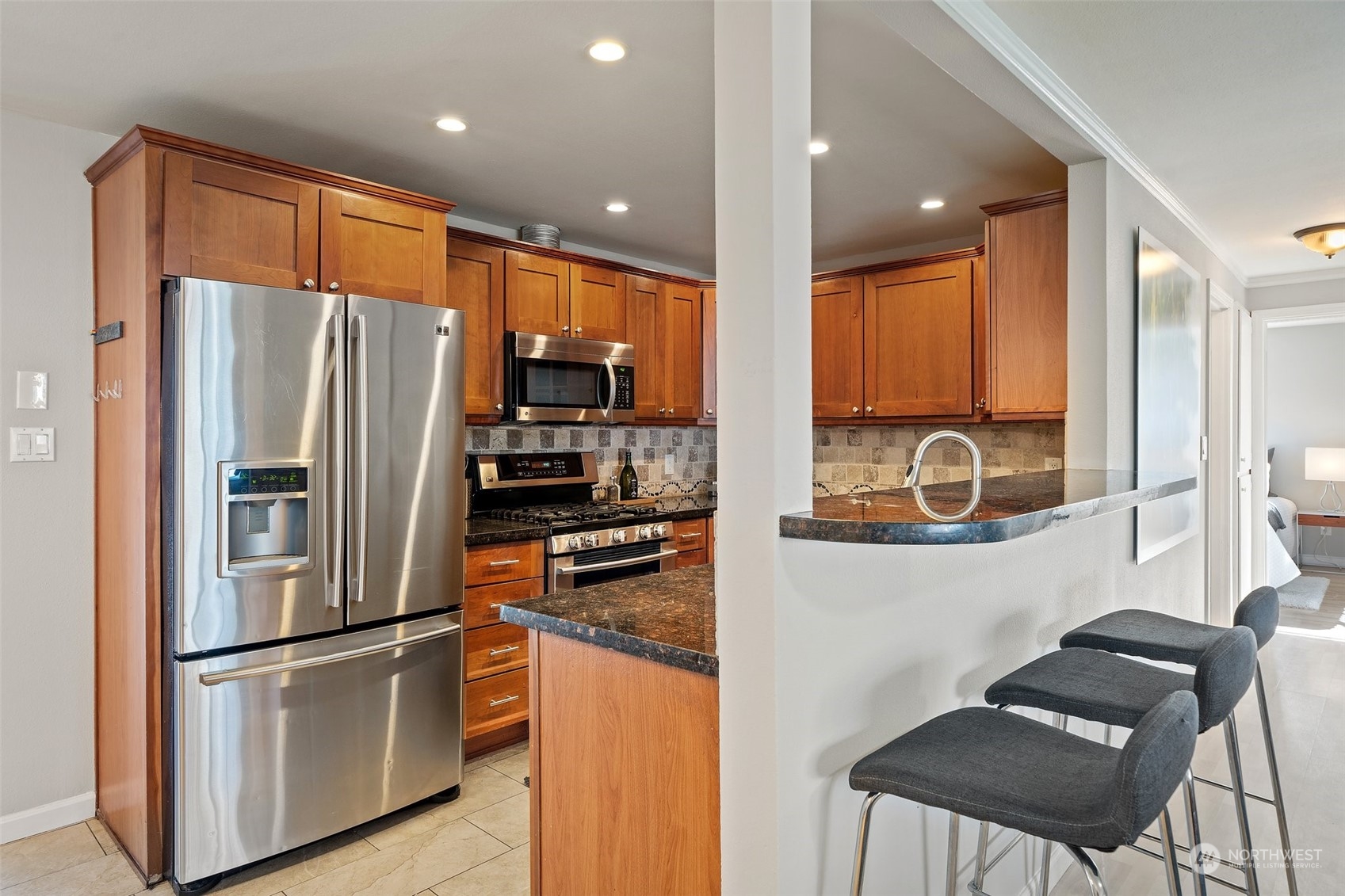 12645 Southeast 170th Street Renton, WA 98058 - Photo 7 of 37 a kitchen with stainless steel appliances granite countertop a refrigerator and a stove top oven