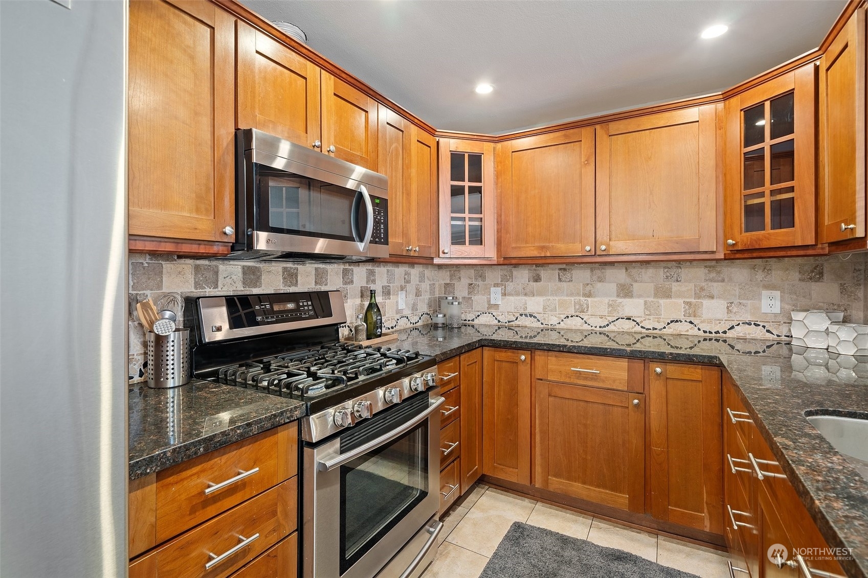 12645 Southeast 170th Street Renton, WA 98058 - Photo 8 of 37 a kitchen with stainless steel appliances granite countertop a stove a sink and a microwave
