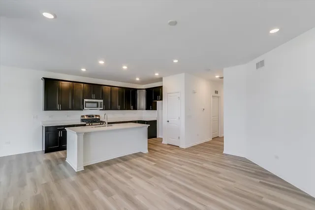 a view of kitchen with sink microwave and stove