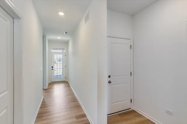 a view of a hallway with wooden floor
