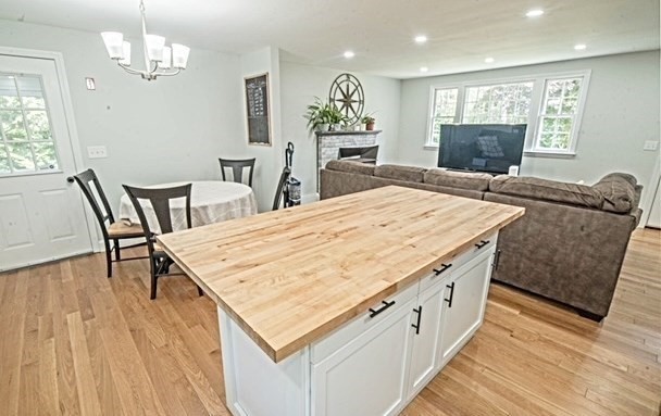 492 Cotuit Road Mashpee, MA 02649 - Photo 3 of 13 a living room with furniture wooden floor and a dining table
