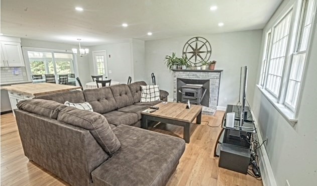 492 Cotuit Road Mashpee, MA 02649 - Photo 5 of 13 a living room with furniture and a fireplace
