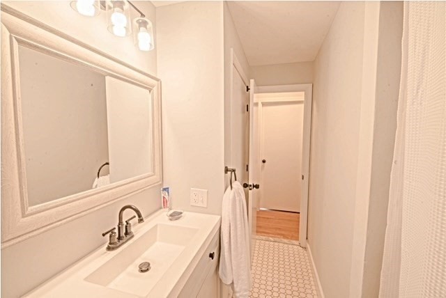 492 Cotuit Road Mashpee, MA 02649 - Photo 8 of 13 a bathroom with a sink a mirror and a shower