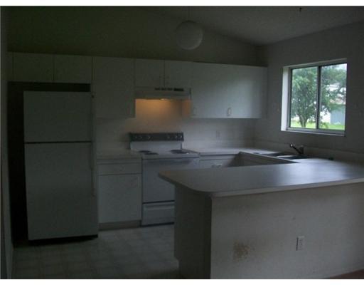 2120 Southwest Vista Road Port St. Lucie, FL 34953 - Photo 2 of 3 a kitchen with a sink a refrigerator and window