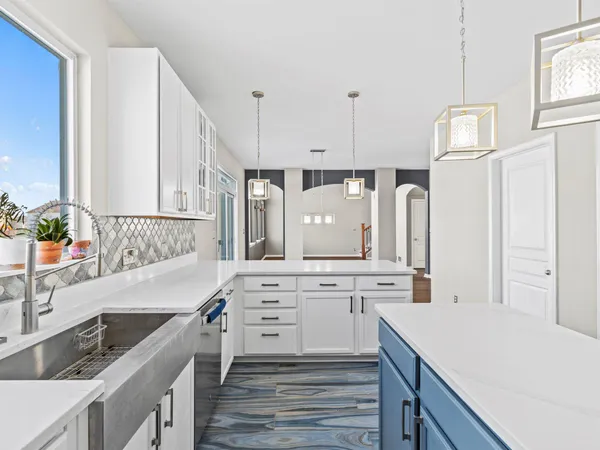 a kitchen with a stove a sink and a refrigerator