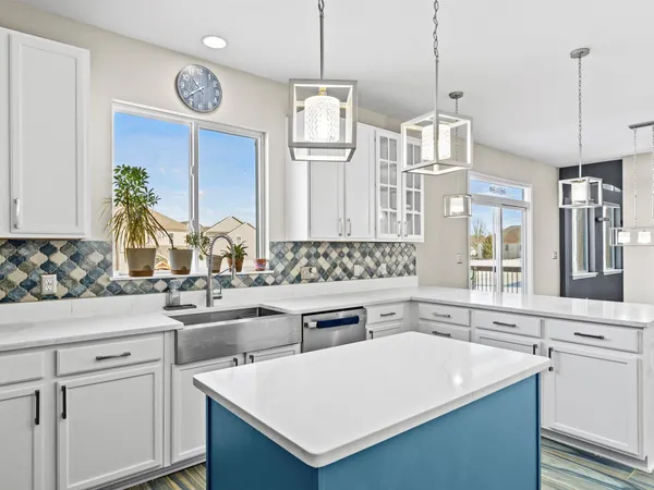 a kitchen with a sink a stove and chairs