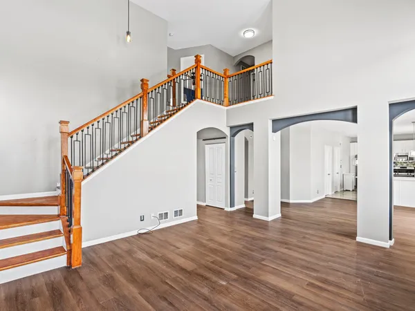 a view of entryway and hall with wooden floor