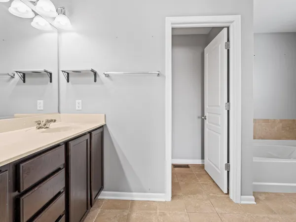 a bathroom with a sink a mirror and a shower