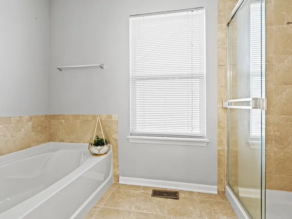 a bathroom with bathtub and shower