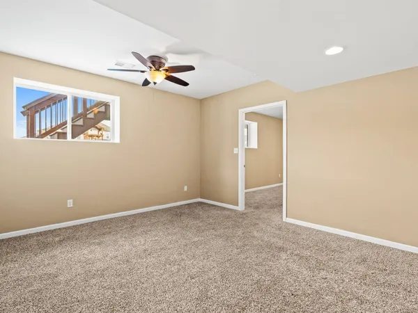 an empty room with closet and windows