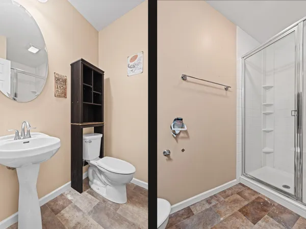 a bathroom with a sink a toilet and shower