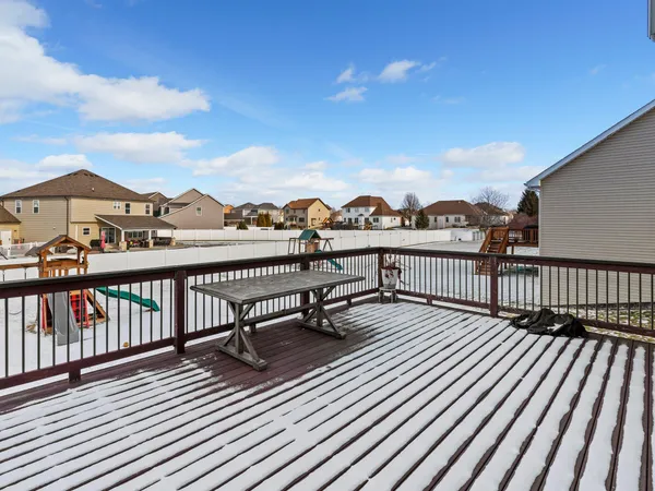 a view of a balcony with wooden benches
