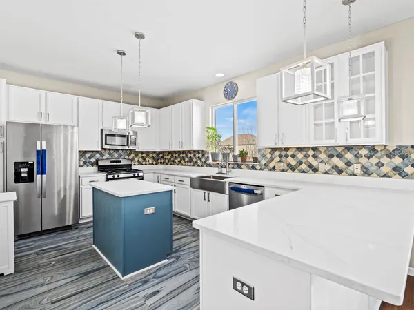 a kitchen with white cabinets and white appliances